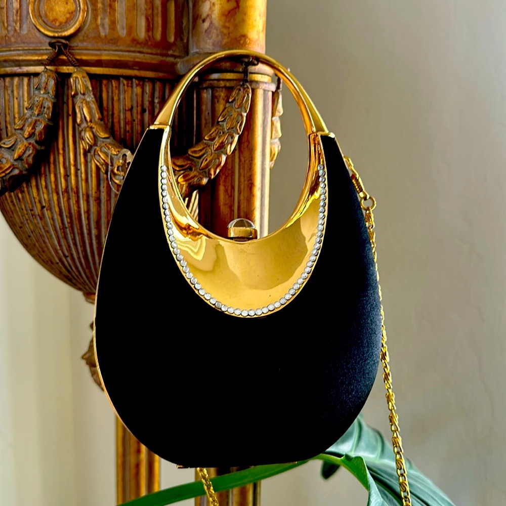 Black satin clutch to closure with gold hardware and trim & crytals.